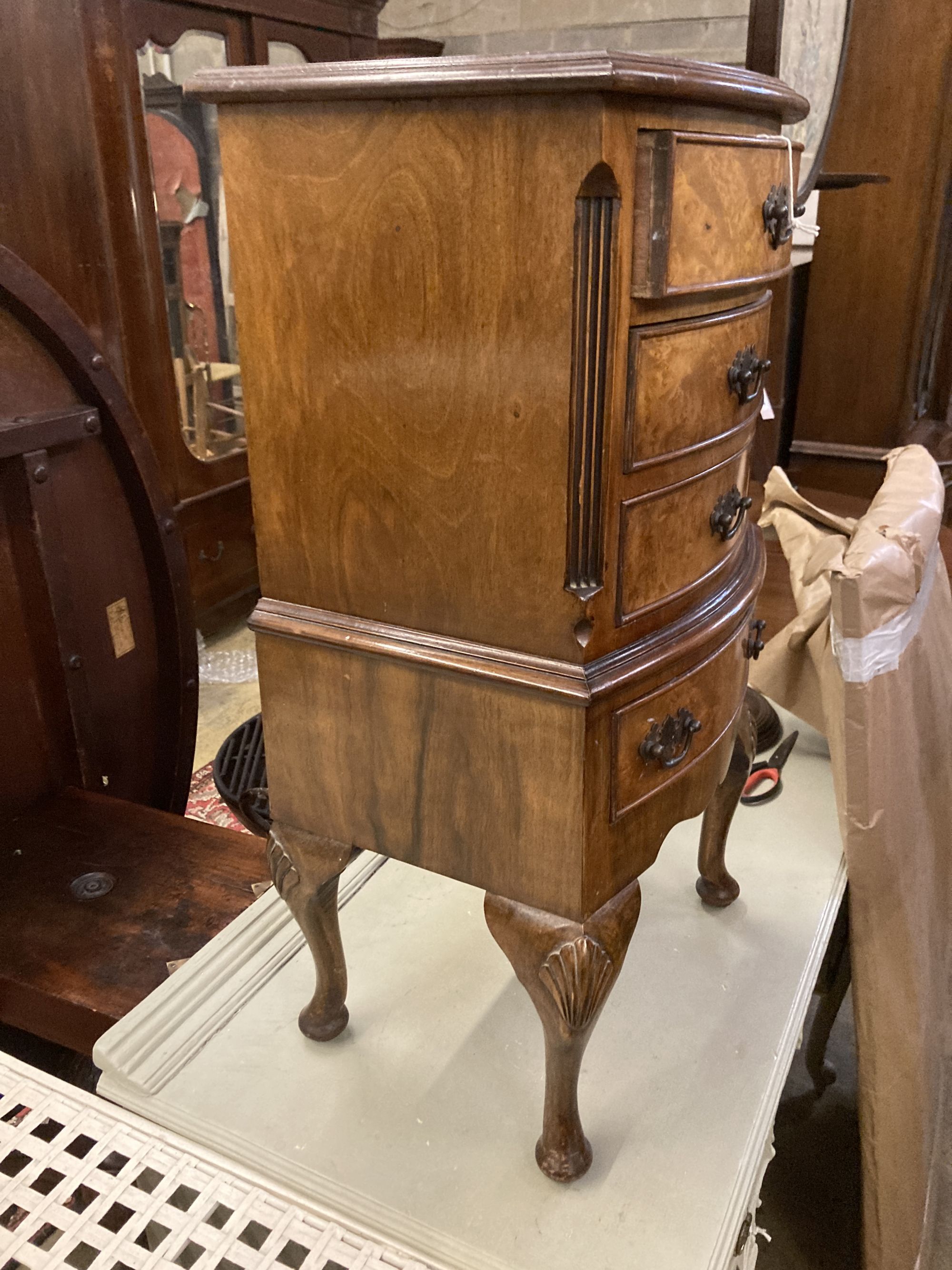 A reproduction walnut four drawer bedside chest, width 42cm depth 29cm height 76cm